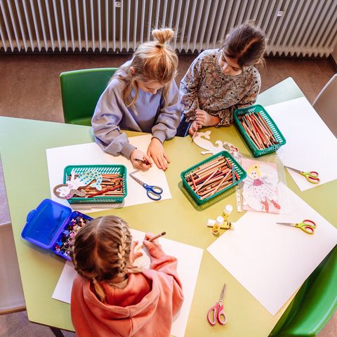 Drei Kinder basteln in Murgels Spielhaus.